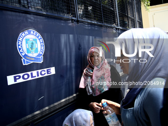 Refugee women in front of a police bus close to the German embassy in Athens on Wednesday 19 July 2017. Refugees, mainly Syrians from the re...