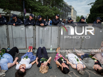 Protesters lie against a barrier guarded by Policemen in front of the Sejm (Lower House of Polish Parliament) building in Warsaw, Poland on...