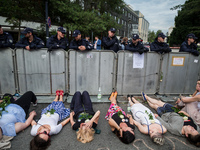 Protesters lie against a barrier guarded by Policemen in front of the Sejm (Lower House of Polish Parliament) building in Warsaw, Poland on...