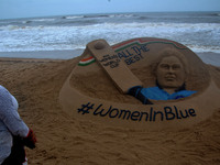 A well wishes sand sculpture for the Indian Women Cricket team along with the portrait of Indian Women Cricket team captain Mithali Raj on t...