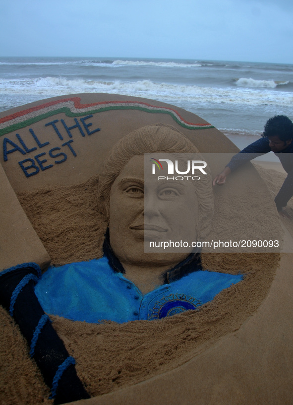A well wishes sand sculpture for the Indian Women Cricket team along with the portrait of Indian Women Cricket team captain Mithali Raj on t...