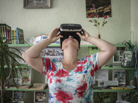 Yana Synytsia wears virtual reality glasses in a village club in Kryva Luka in Donetsk region, ATO zone, Ukraine on July 24, 2017. Yana is a...