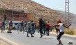 Israeli soldiers take up positions during clashes with Palestinian protesting against the...