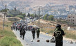 Israeli soldiers take up positions during clashes with Palestinian protesting against the...