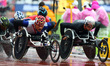 L-R Rawat Tana of Thailand  and Marcel Hug of Switzerland compete Men's 5000m T54 Final du...