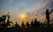 Hundreds fishermen are fishing using the good weather during a sunset at the Black sea por...