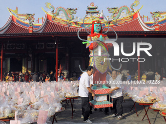 Indonesian Chinese community raised the statue of the god in the Hungry Ghost Festival celebration held at East Mountain monastery in Medan,...