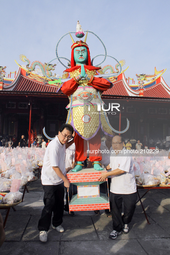 Indonesian Chinese community raised the statue of the god in the Hungry Ghost Festival celebration held at East Mountain monastery in Medan,...