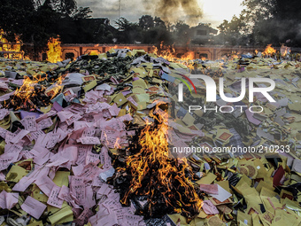 The burning of paper money made from the written words of the ancestral Indonesian Chinese community in celebration of the Hungry Ghost Fest...