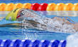 Jiayu Xu of China competes in final the men's 50m backstroke during the swimming competiti...