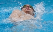 Poland's Dawid Szwedzki competes in a heat of the men's 400m individual medley during the...