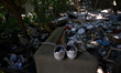 Piles of trash, including thousands of syringes and empty heroin bags, are found at the he...
