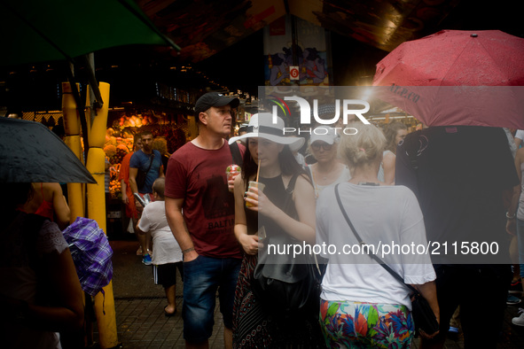 Tourists visit La Boqueria market on August 8, 2017 in Barcelona, Spain. In the past year there have been a series of protests as residents...