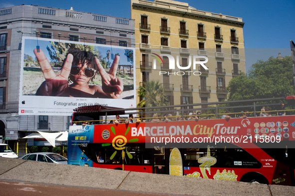 Tourists go by a touristic bus  on August 8, 2017 in Barcelona, Spain. In the past year there have been a series of protests as residents co...