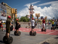 A group of tourists go by segways  on August 8, 2017 in Barcelona, Spain. In the past year there have been a series of protests as residents...