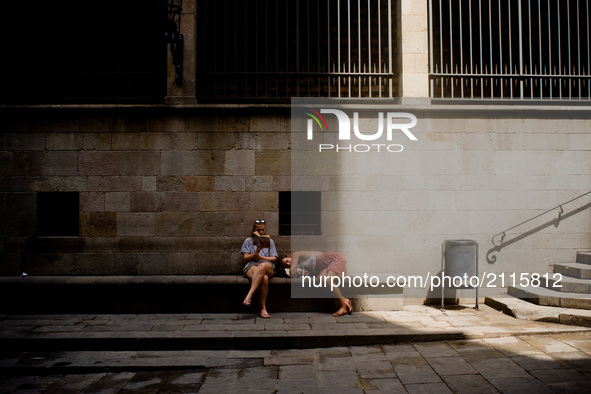 Tourists take a rest in the Gothic Quarter of Barcelona, Spain,  on August 8, 2017. In the past year there have been a series of protests as...