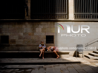 Tourists take a rest in the Gothic Quarter of Barcelona, Spain,  on August 8, 2017. In the past year there have been a series of protests as...