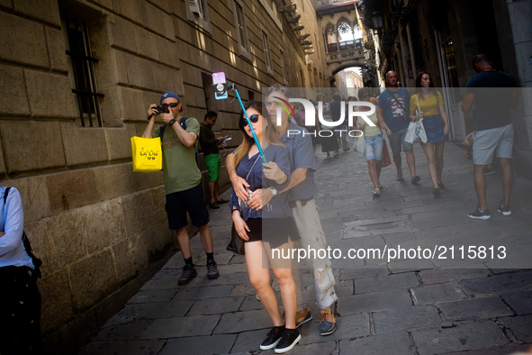 A couple takes a selfie by the streets of the Gothic Quarter in Barcelona, Spain, on August 8, 2017. In the past year there have been a seri...