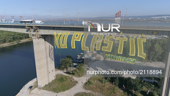Greenpeace activists wave a big 50 metters long and 15 metters tall transperant wich says: No Plastic" over 60 metters high Asparuhov bridge...