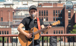 A pusker is pictured while he performs, against the backdrop of St. Paul's Cathedral, in a...