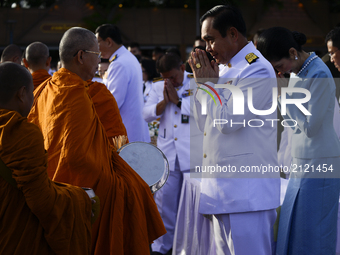 Thai Prime Minister Prayuth Chan-O-Cha gives alms to Buddhist monks to celebrate the Queens Sirikit' 85th birthday in Bangkok, Thailand, 12...