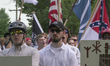 Free speech demonstrators hold shields and flags during the Unite the Right free speech ra...