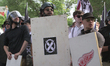 Free speech demonstrators hold shields and flags during the Unite the Right free speech ra...