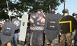 Demonstrators hold shields during the Unite the Right free speech rally at Emancipation Pa...