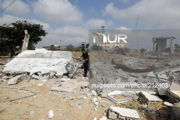 A Palestinian man inspects the damage following a month of fighting between the Israeli military and Hamas militants as he stands close to t...