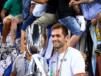 Lazio's midfielder from Bosnia-Herzegovina Senad Lulic holds the trophy  after the Italian Supercup match between Juventus and SS Lazio at S...