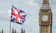 An Union Flag is seen waving on the top of a souvenir shop, against the backdrop of the El...