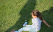 A little girl wallows in the grass as pro-government supporters of President Recep Tayyip...