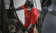 Worker take apart old gallopper vehicle at mohenic garages yard in Paju, South Korea. A 20...