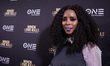 Director Tasha Smith, poses for a photo on the red carpet, at TV One's DC Premiere of When...