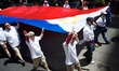 A huge Philippine flag is carried by members of a non-profit organization in the parade at...