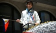 Filipino Olympic Ice Skater Michael Martinez waves a Philippine flag at the 116th annivers...