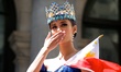 2013 Miss World winner Megan Young gives a kiss at the crowd at the 116th year celebration...
