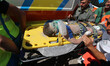 Italian emergency workers evacuate on a stretcher a boy who was was trapped by rubble, in...