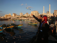  Palestinian activists throw bottles into the sea containing messages against the siege of the Gaza Strip at the port in Gaza City on August...