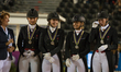 The Danish dressage team arrives at the price giving ceremony for the team dressage compet...