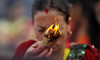 Nepalese devotees offering oil and butter lamps during Teej festival celebrations at Pashu...