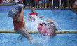 A man fall down to the water during pilow battle. In order celebrate Indonesia Independenc...