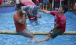 A man hit his opponent on pilow battle. In order celebrate Indonesia Independence day, peo...