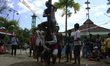 Indonesian men compete for prizes in climbing the greasy pole called "panjat pinang" durin...
