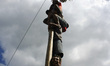 Indonesian men compete for prizes in climbing the greasy pole called "panjat pinang" durin...