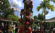Indonesian men compete for prizes in climbing the greasy pole called "panjat pinang" durin...