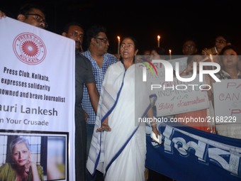 West Bengal Chief Minister Mamata Banerjee participates along with working journalists at a candle light vigil to protest the murder of vete...