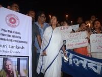West Bengal Chief Minister Mamata Banerjee participates along with working journalists at a candle light vigil to protest the murder of vete...