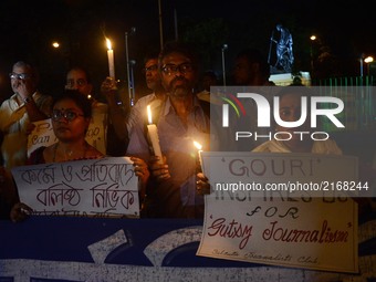 Indian journalists participates at a candle light vigil to protest the murder of veteran journalist Gouri Lankesh at press club in Kolkata ,...
