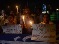 Indian journalists participates at a candle light vigil to protest the murder of veteran journalist Gouri Lankesh at press club in Kolkata ,...